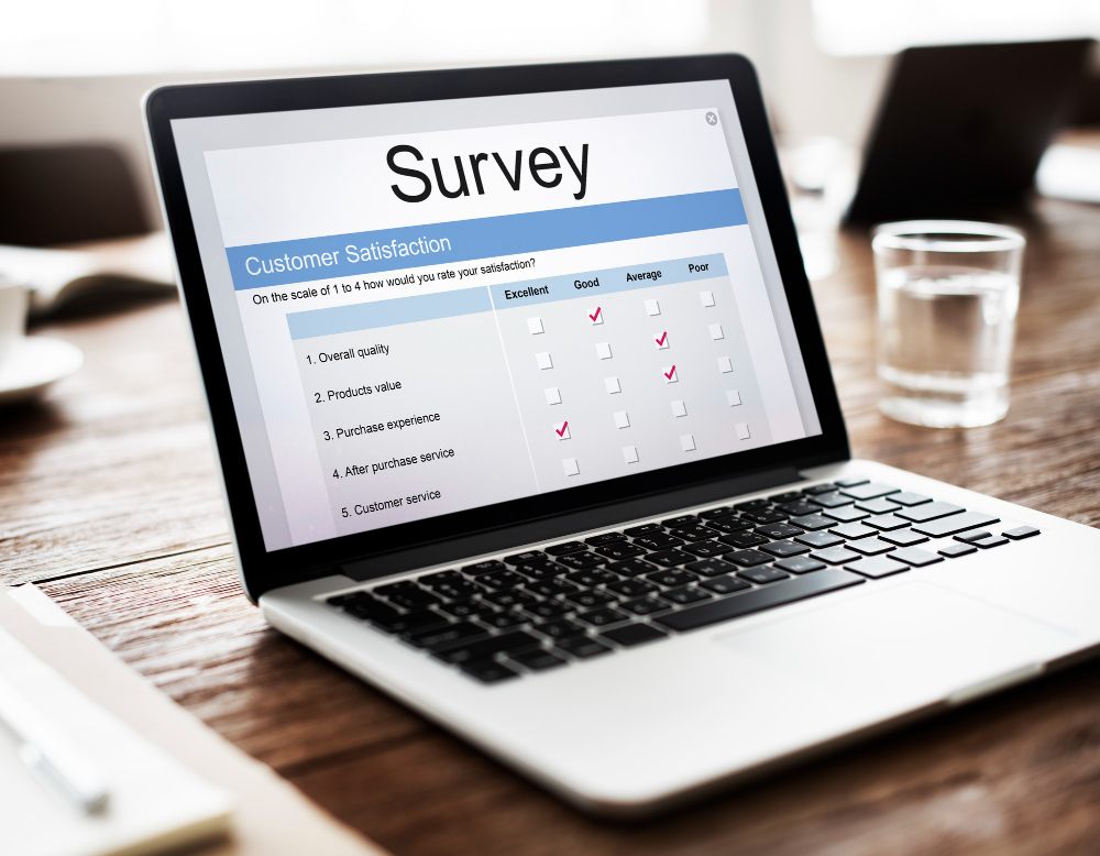 online customer satisfaction survey questions are shown on a laptop screen