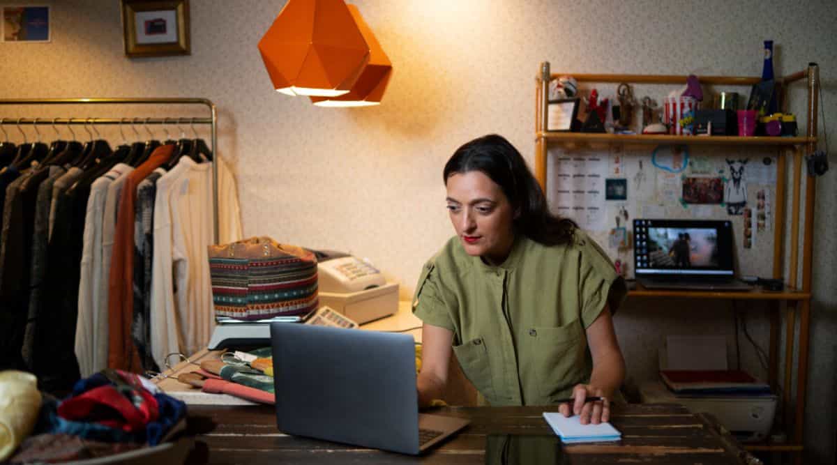 A savvy woman promoting clothes from a thrift store emphasizes the "Benefits of Market Research for Small Businesses" as she showcases unique finds and affordable fashion.